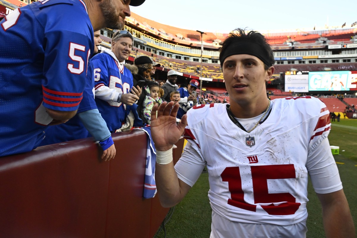 Nov 19, 2023; Landover, Maryland, USA; New York Giants quarterback Tommy DeVito (15) is congratulated by fans after the game against the Washington Commanders at FedExField.